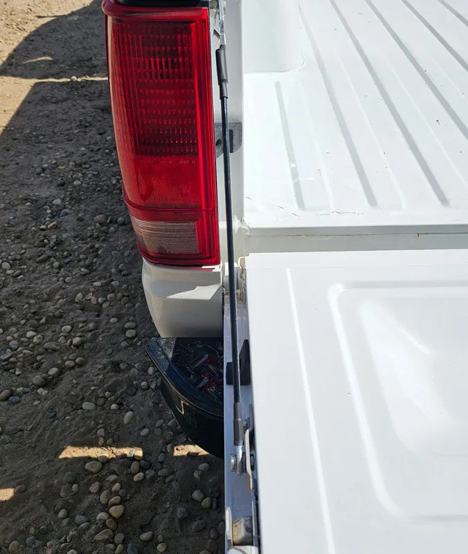 Tailgate cables shown installed on an 82-94 GMC Chevy S10 truck