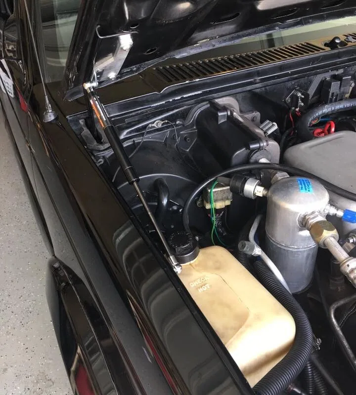 83-93 hood strut kit installed on black chevy truck