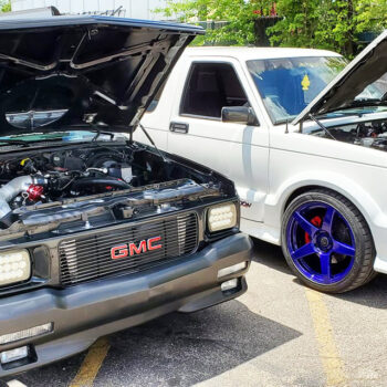 83-93 hood strut kit installed on white and black chevy truck