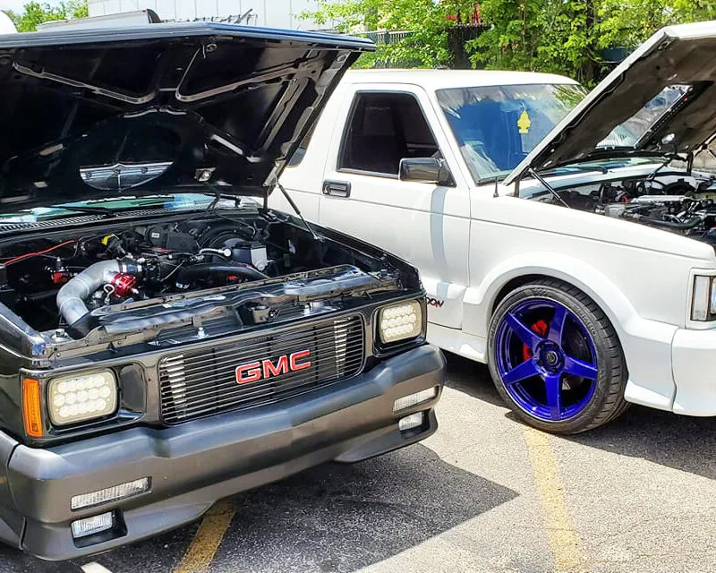83-93 hood strut kit installed on white and black chevy truck