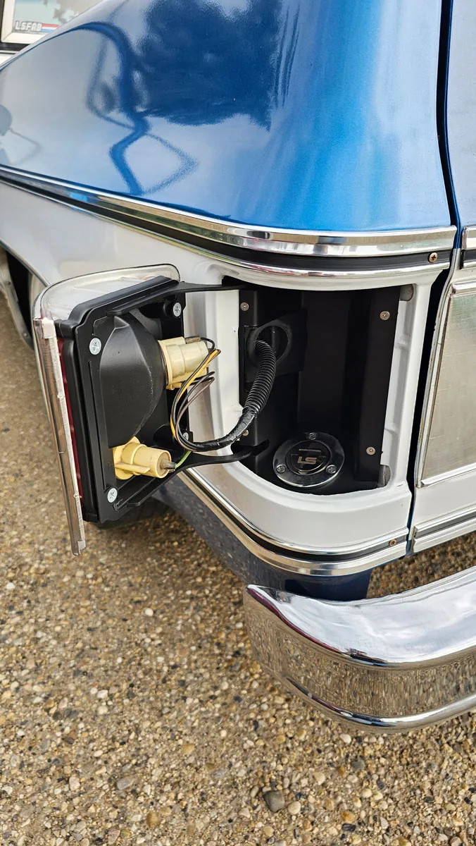 Squarebody fuel filler kit hidden behind the taillight on a 1973-91 Chevy truck bedside