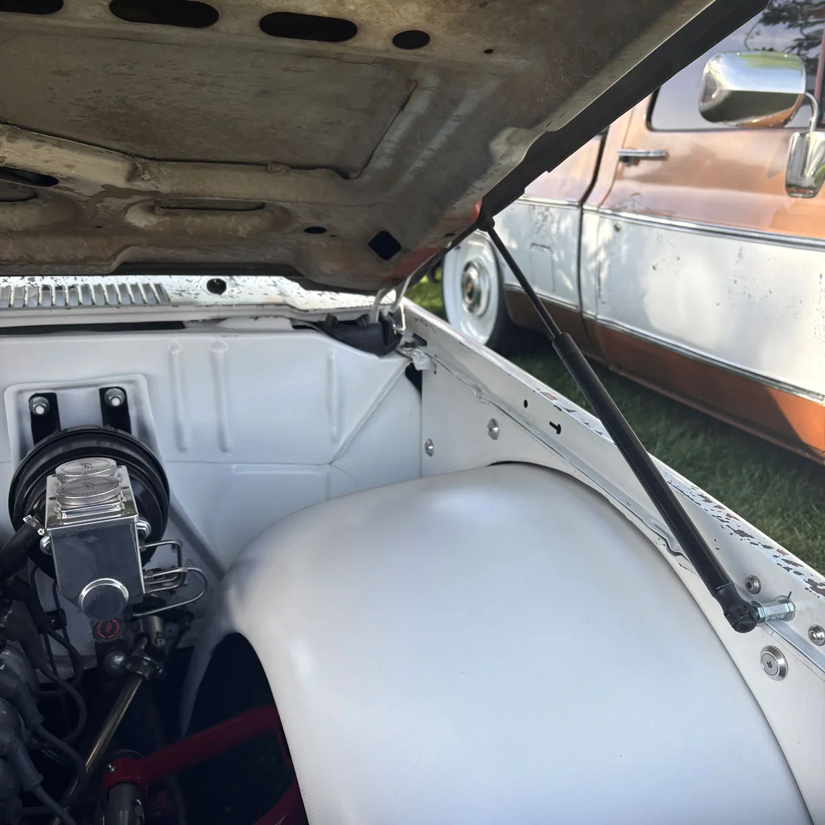 Hood strut kit for 73-87 Chevy squarebody truck, hardware laid out