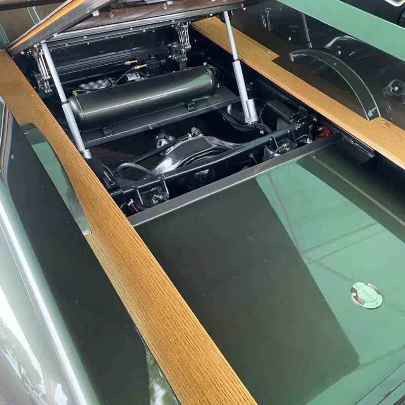 Tilt bed scissor hinges shown installed on a Chevy truck bed