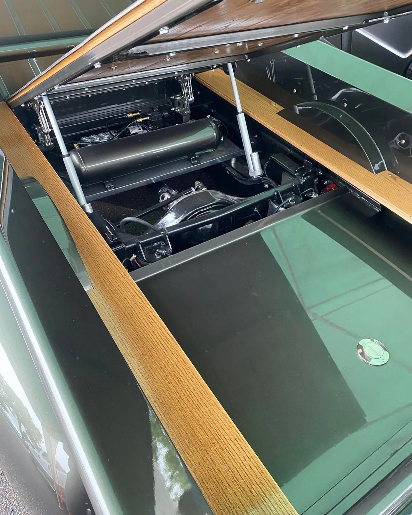 Tilt bed scissor hinges shown installed on a Chevy truck bed