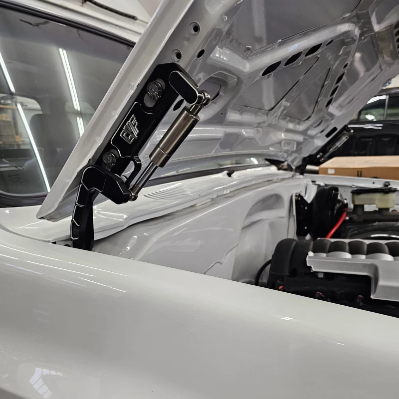Black billet hood hinges shown installed on an 81-87 Chevy squarebody truck
