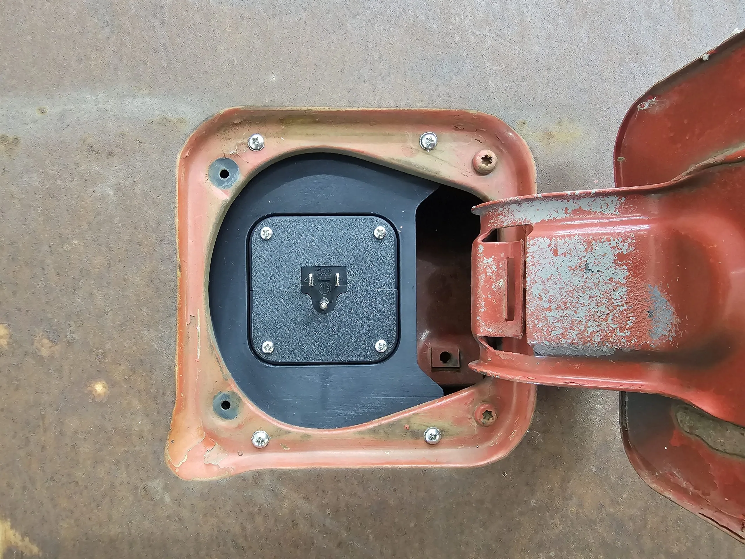 Fuel filler charger port for 77-91 GMC Chevy truck, close-up of the mounting flange