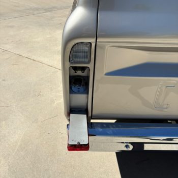Polished stainless fuel filler neck in a 67-72 C10 taillight housing